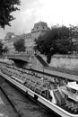 Tourist boat floats on the channel near Notre Dame de Paris. Royalty Free Stock Photo